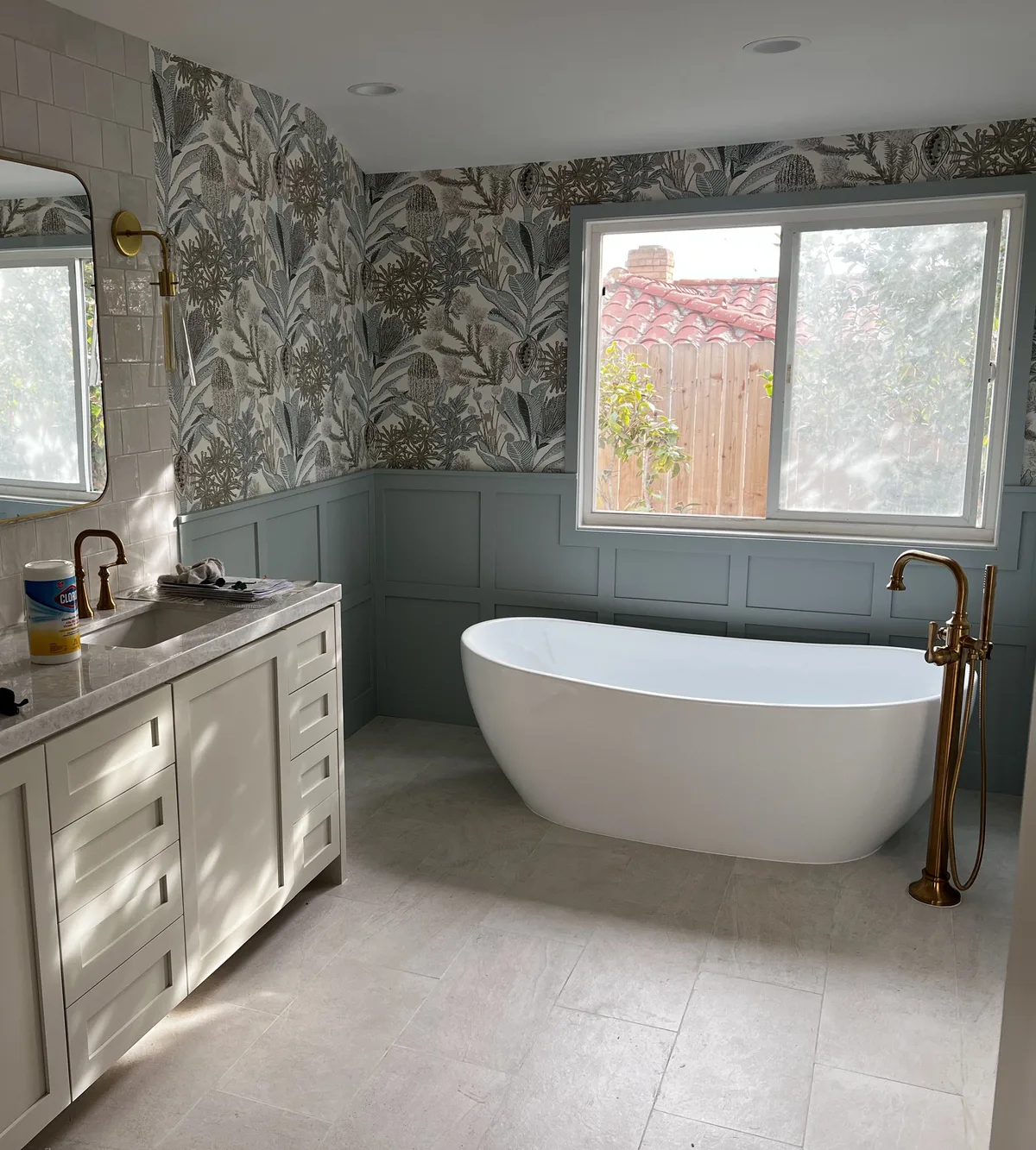 Remodeled bathroom with freestanding tub and brass fixtures