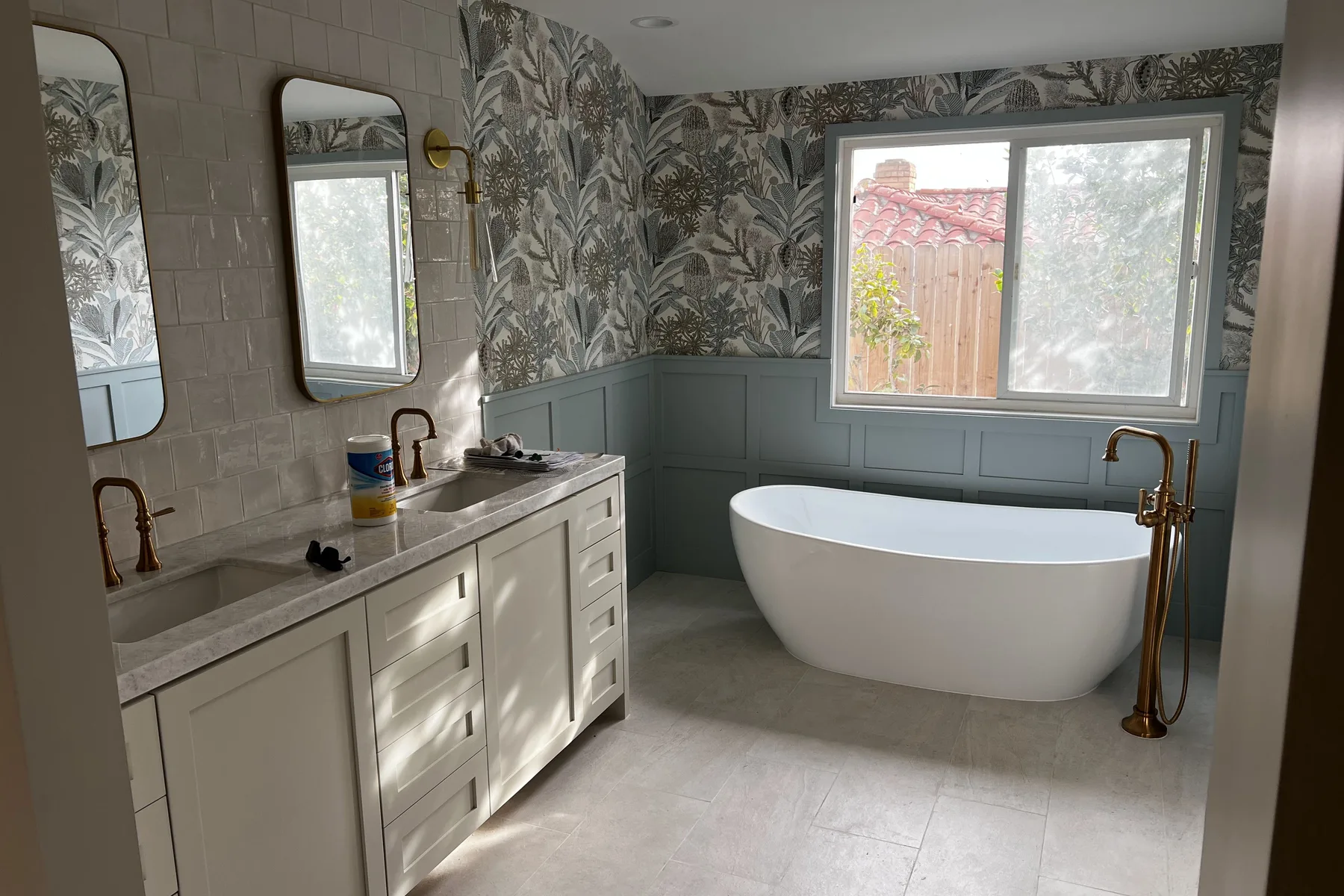 Remodeled bathroom with freestanding tub and brass fixtures