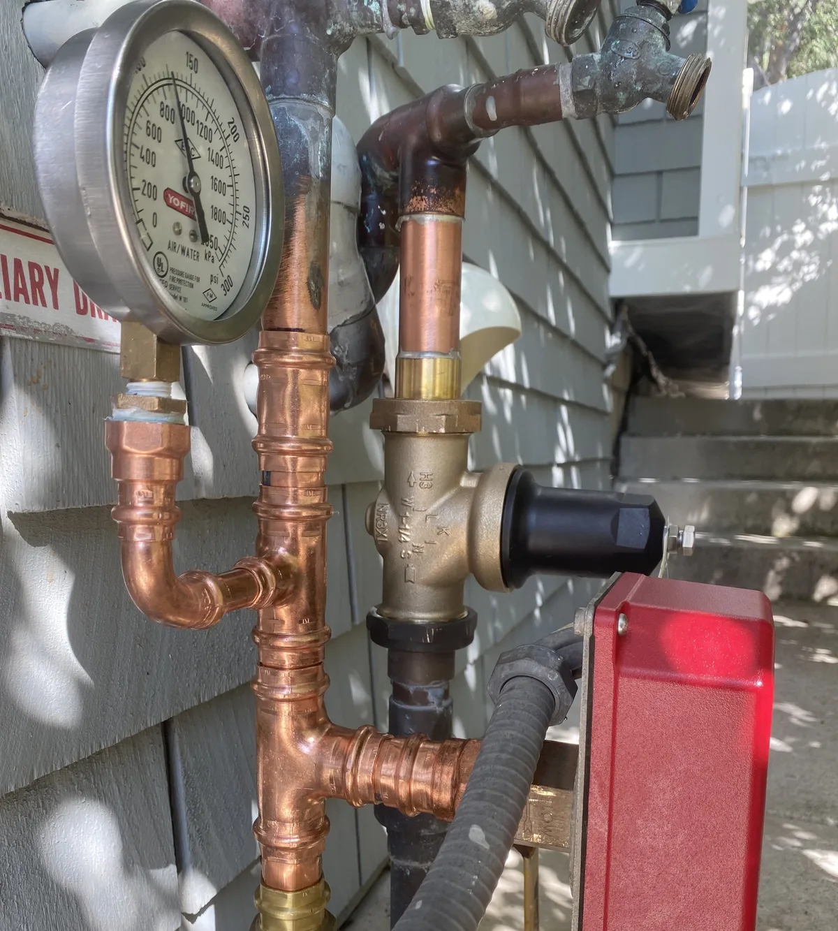 Pressure test gauge on a copper water line during leak detection