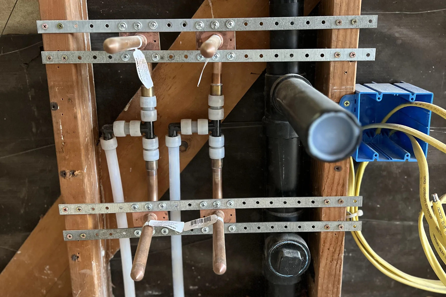 New PEX repipe supply lines and drain installed in open wall framing