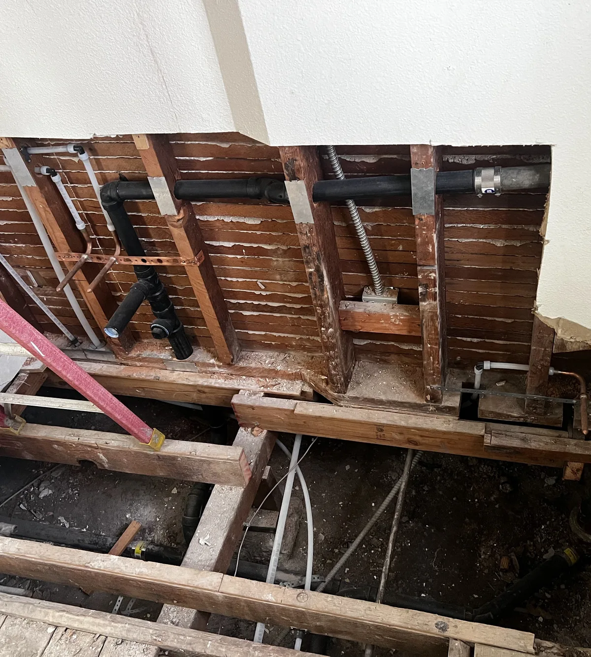 Floor opened to access and repair leaking pipes under a home
