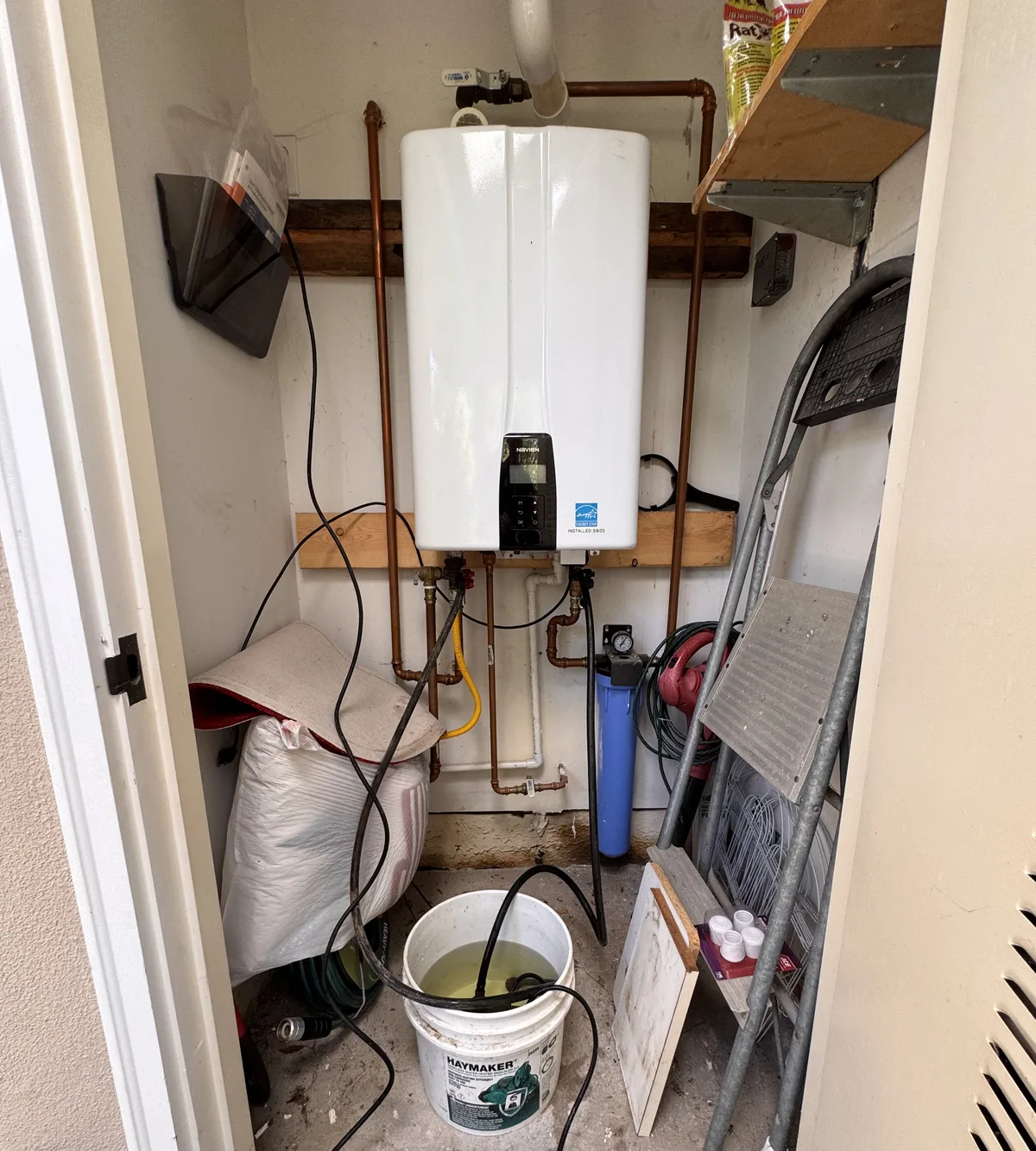 Tankless water heater being flushed to remove hard water scale