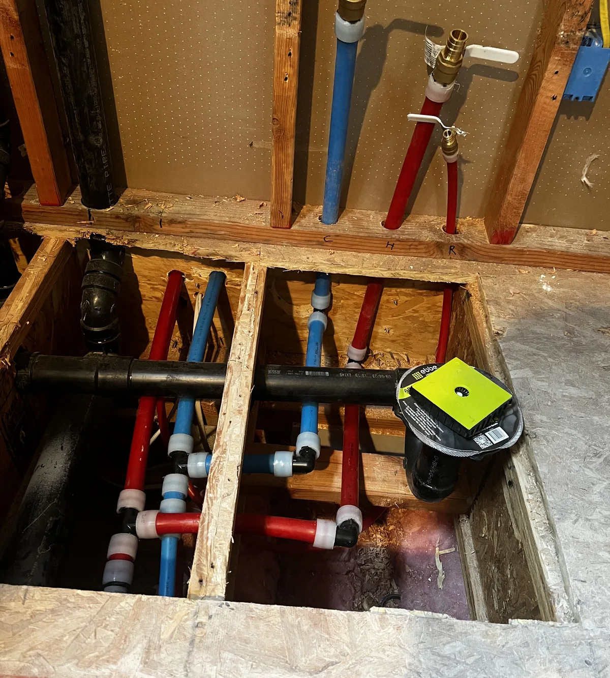 Opened floor exposing water and drain lines during leak locating